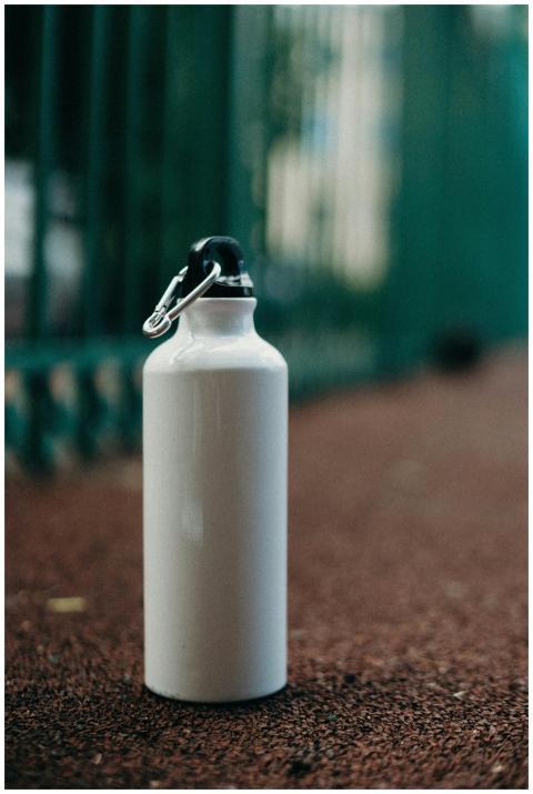 White eco-friendly water bottle on a sports track