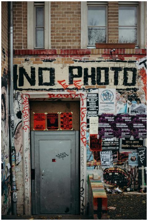 Street art with graffiti and posters at a Berlin b