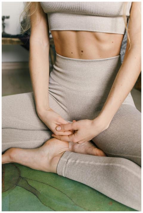 Close-up of a woman in a meditative pose wearing c