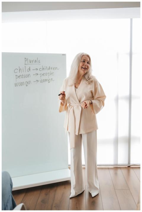 Senior woman teaches grammar concepts like plurals