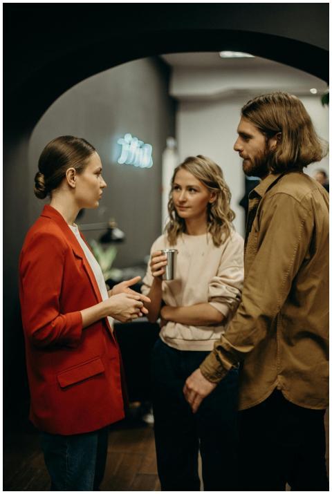 Three colleagues having a discussion in a modern o