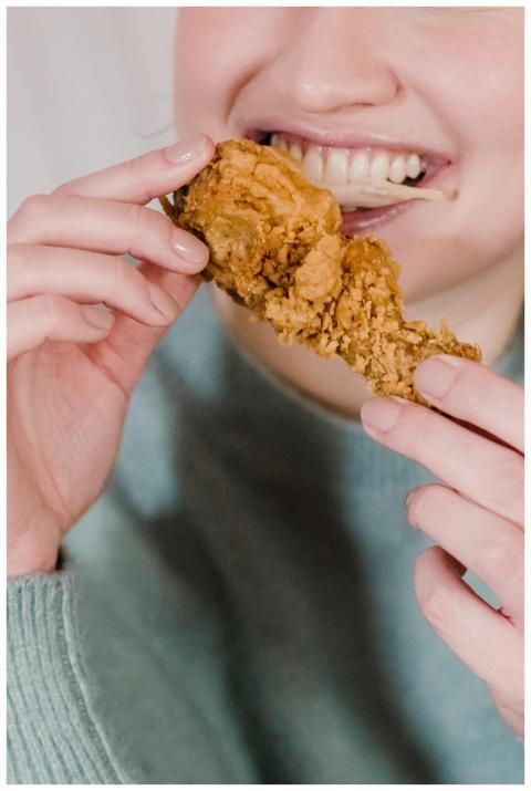 Crop anonymous happy female eating and enjoying sp
