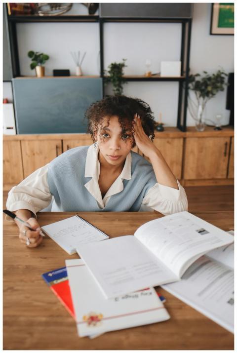A young woman deeply engrossed in studying at a de