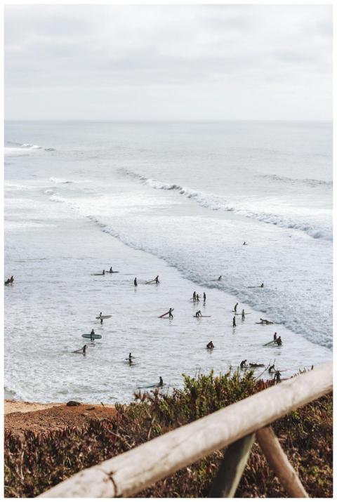 A vibrant scene of surfers riding waves on a cloud