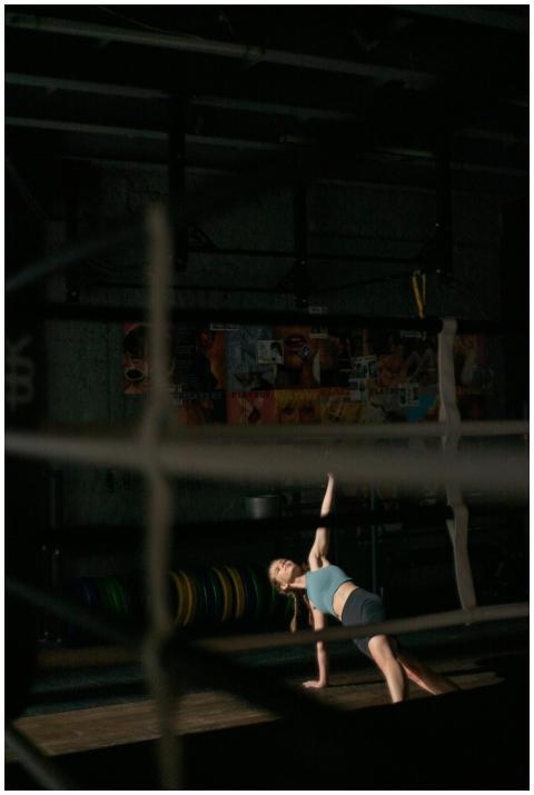 Woman engaging in a dynamic stretch exercise in a