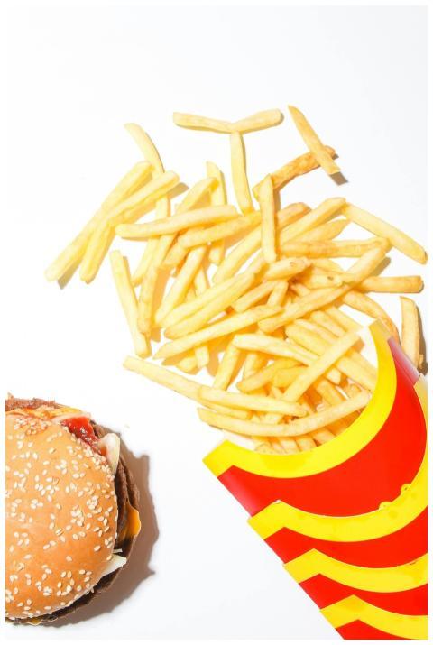 Close-up of crispy french fries and a juicy burger