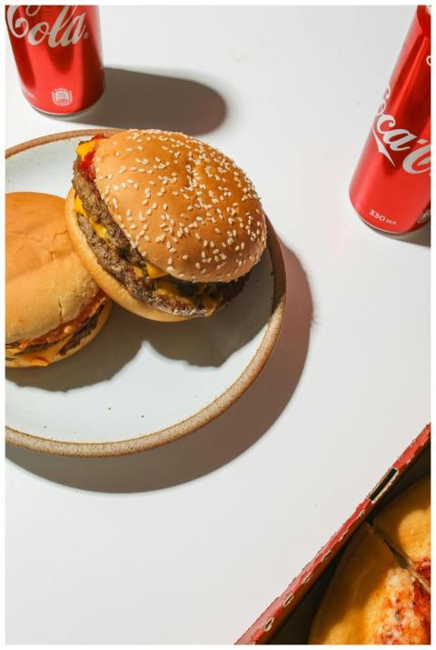 Top view of delicious cheeseburgers with Coca-Cola