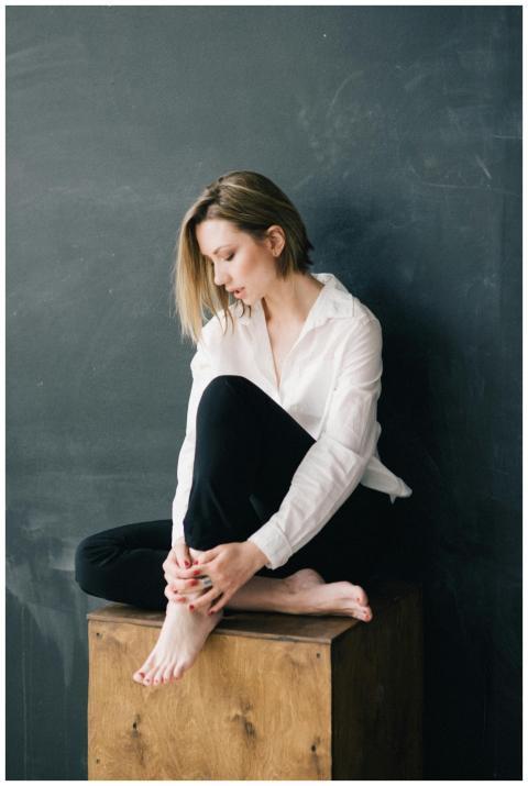 Portrait of a caucasian woman sitting on a wooden