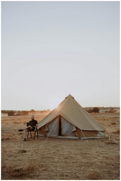 Full body of male traveler sitting on chair with l