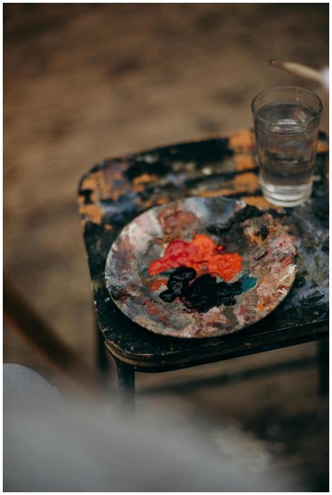 Artistic setup featuring acrylic paints on a woode