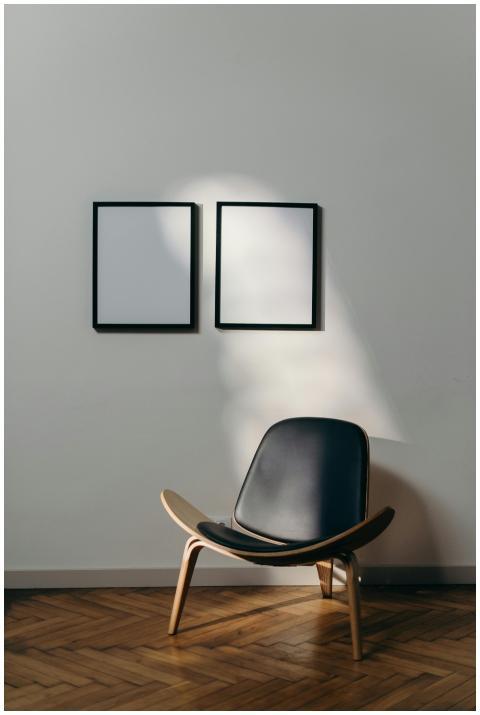 Stylish minimalist interior with black chair and b
