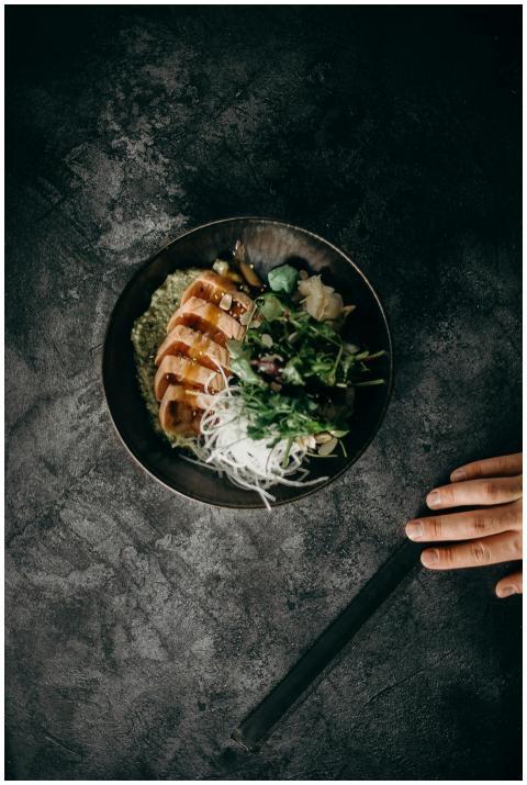 A delectable Asian dish served with fresh salad an