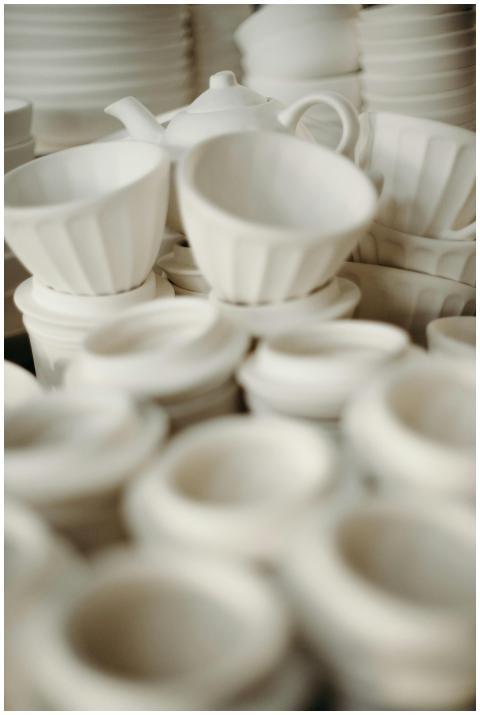 Minimalist white ceramic cups and bowls arranged a