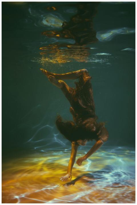 An artistic underwater photo capturing a woman in