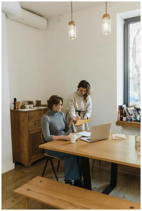 Two women engaged in a collaborative discussion in