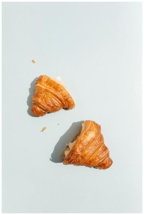 Top view of fresh croissant halves on a minimalist
