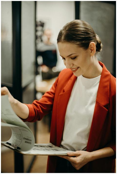 Confident businesswoman reading documents in the o