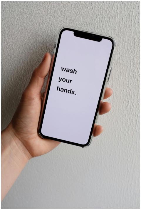 Crop anonymous person demonstrating modern cellpho