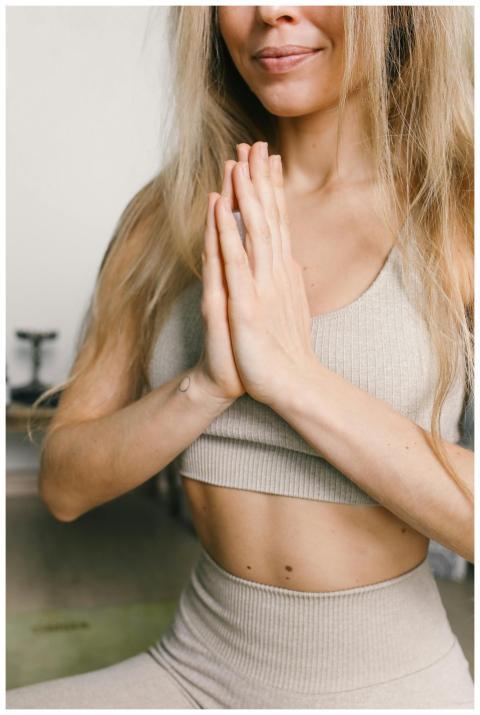 A woman in activewear practicing yoga meditation i