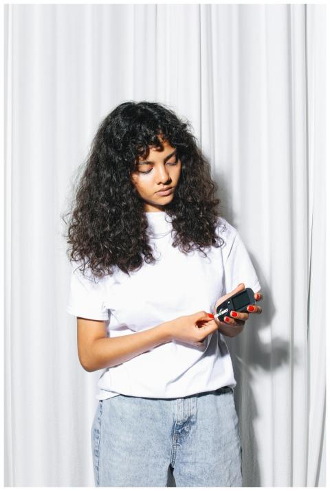 Young woman using a glucometer to test blood sugar
