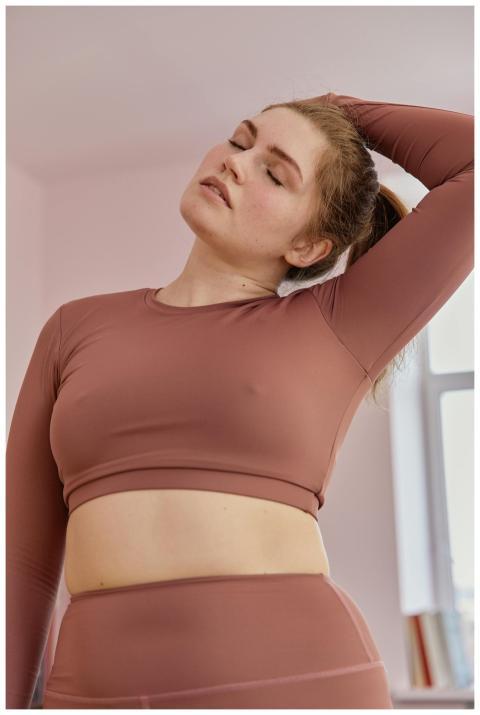 A confident plus-size woman practicing yoga indoor