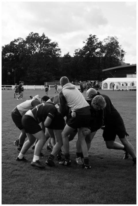Men engaged in a rugby match, showcasing teamwork