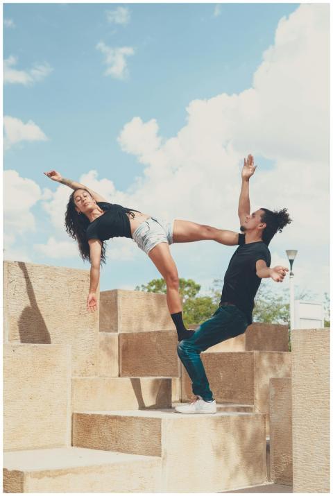 Energetic acro yoga couple practicing balance and