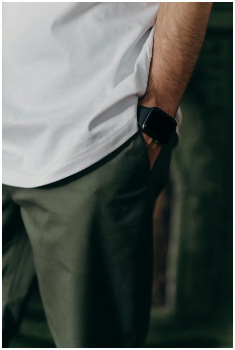 Close-up of a man wearing a white t-shirt and smar