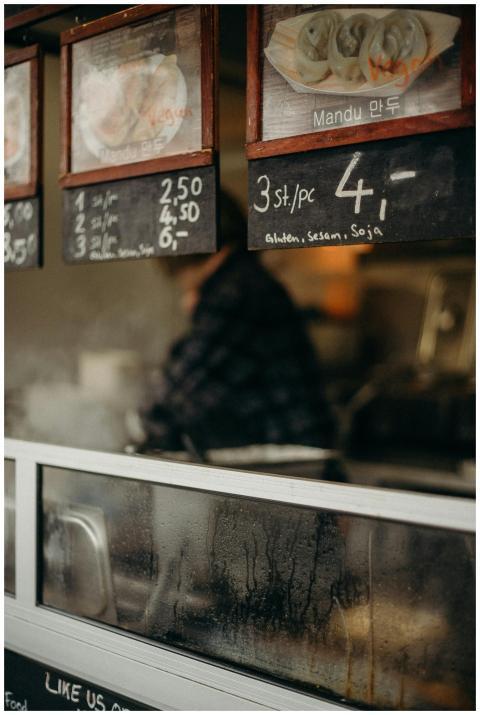 Close-up of a Korean food stall menu showcasing ma