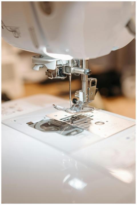 Detailed view of a sewing machine needle ready for