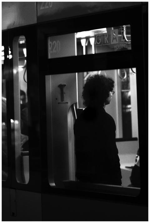 A monochrome silhouette of a person on a nighttime