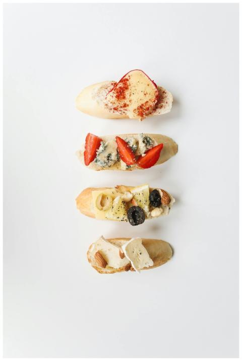 Top-down view of assorted crostini with cheese, fr