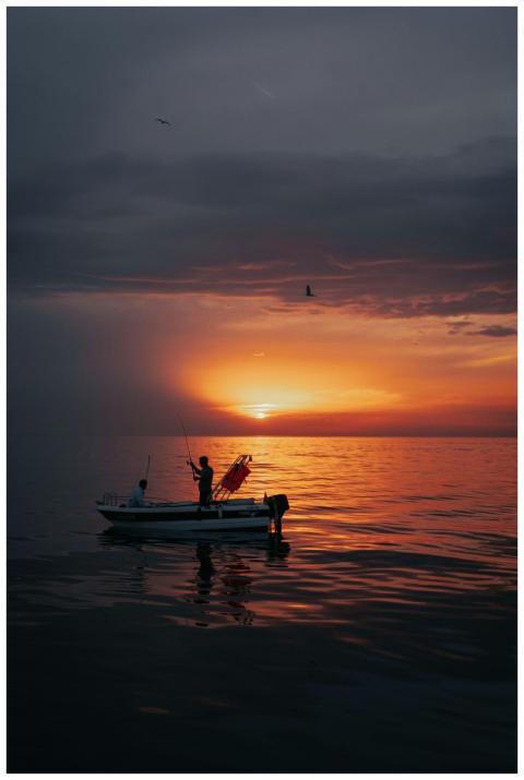 Fishermen enjoy a peaceful sunset fishing trip on