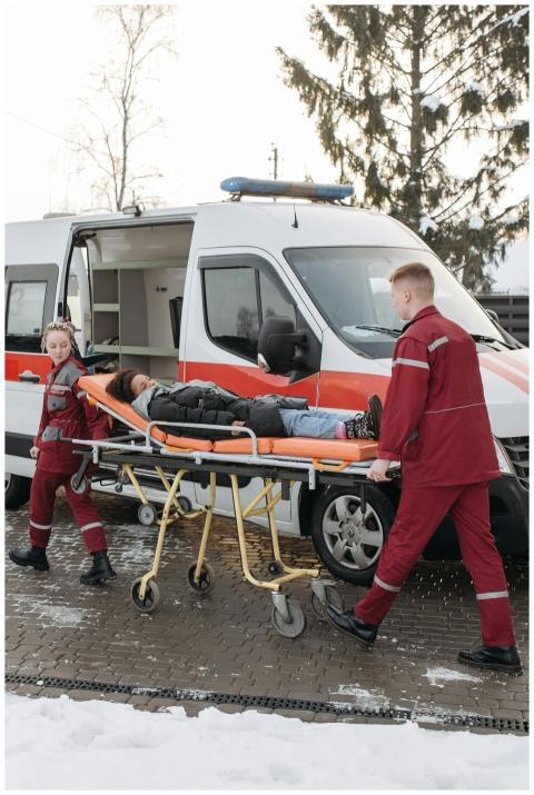 Paramedics transferring a patient on a stretcher t