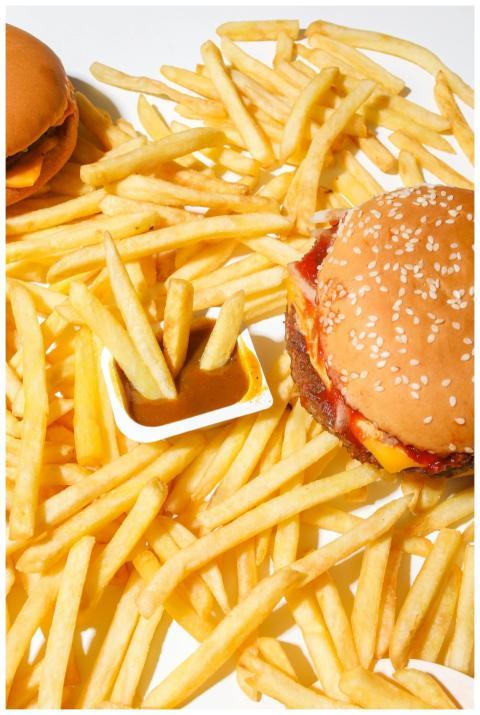 A delicious burger and fries on a white background
