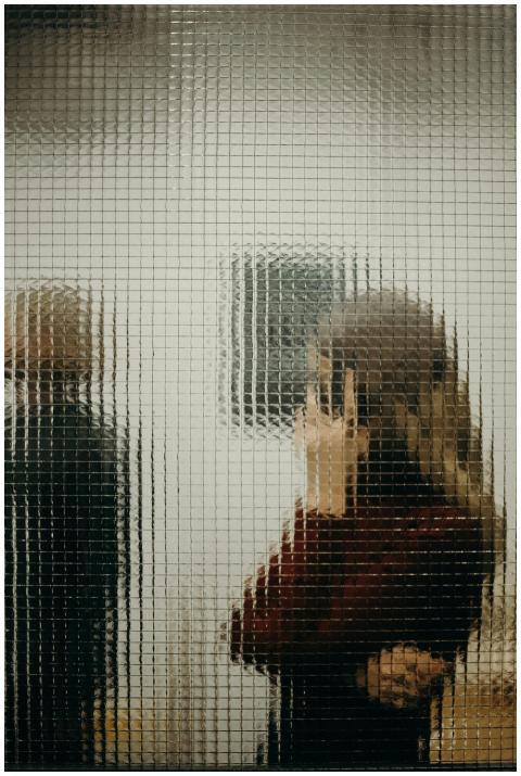 Abstract image of people seen through textured gla