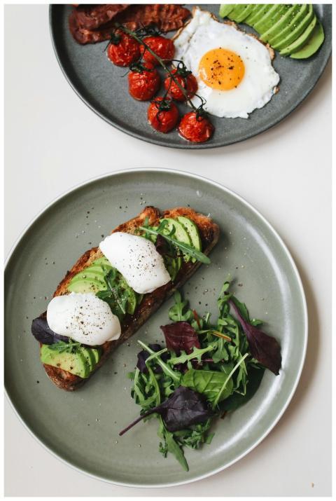 Delicious avocado toast with poached eggs and a sa