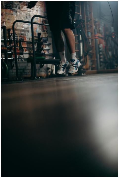 Jumping exercise in a gym, highlighting fitness an