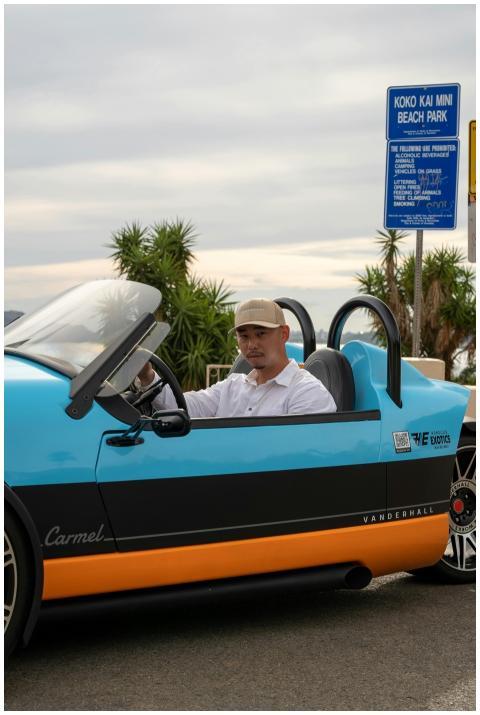 Man driving a blue Vanderhall Carmel near Koko Kai