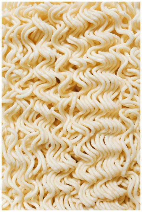Detailed close-up of raw instant noodles showcasin