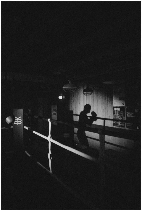 A striking monochrome silhouette of a boxer shadow