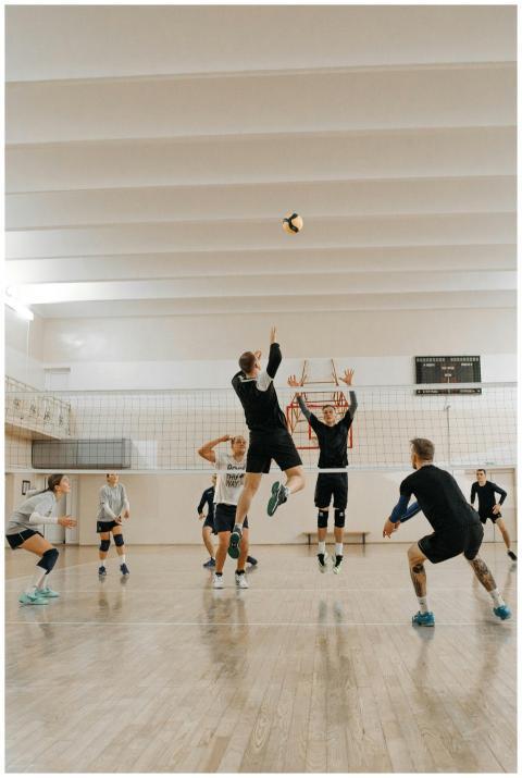 Male athletes compete fiercely in an indoor volley