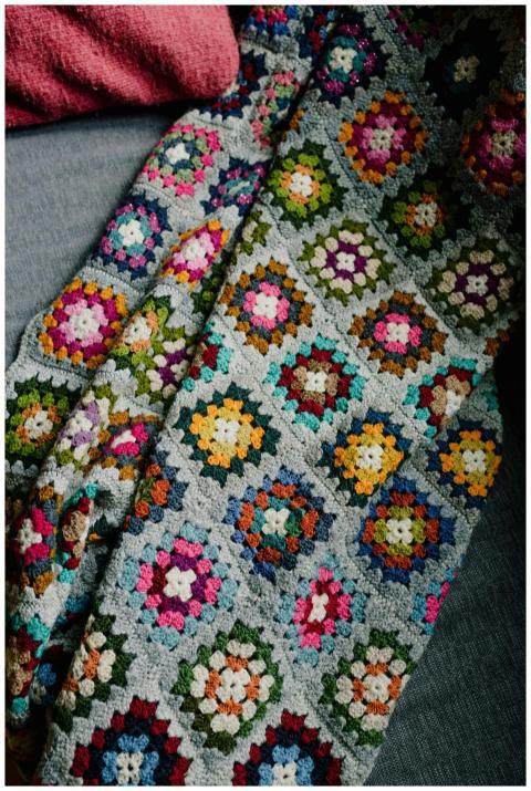 A vibrant handmade crochet blanket featuring geome
