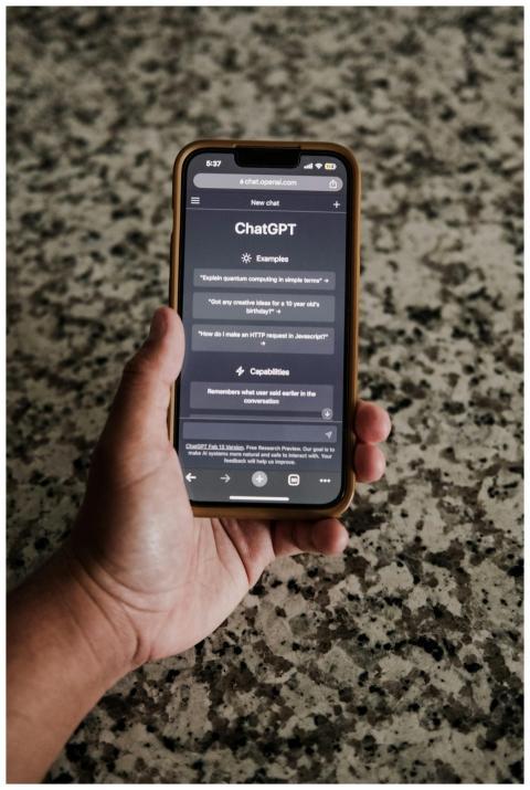 A close-up of a hand holding a smartphone with Cha