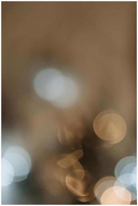 Blurred bokeh lights in warm tones create an abstr
