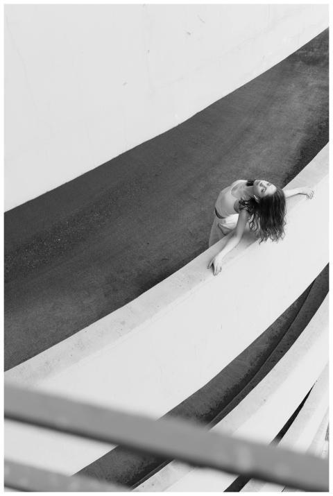 Moody shot of woman in a parking ramp, showcasing