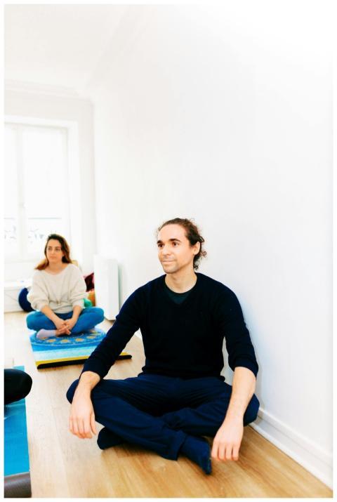 People practicing yoga and meditation in a bright