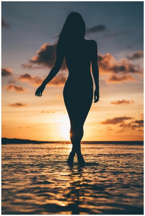 Graceful silhouette of a woman walking along Honol