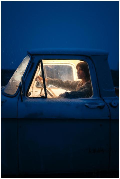 Person driving a vintage truck on a snowy night, i