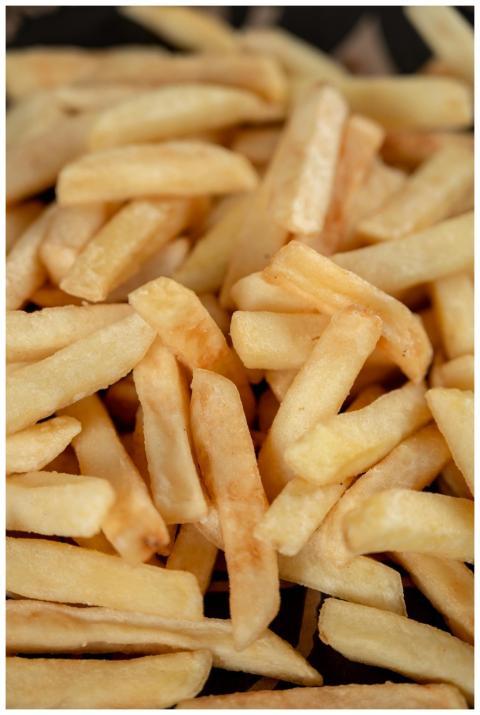 Close-up view of crispy golden french fries showca